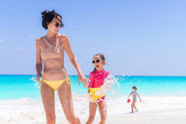 istock Mother with two kids enjoy beach vacation 943818636