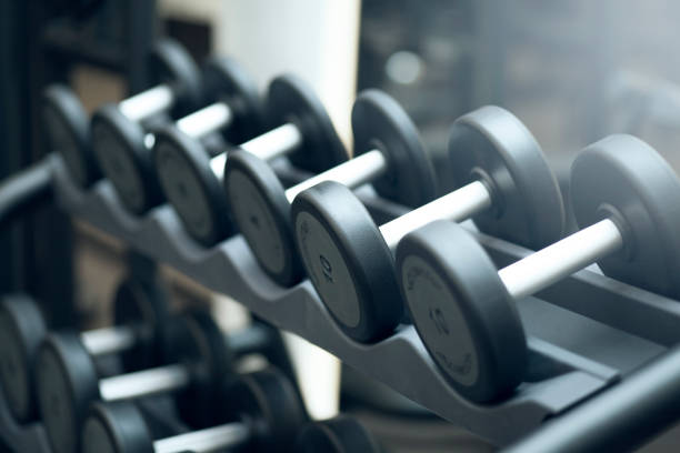 istock many black dumbbells in dark weight room 943819084