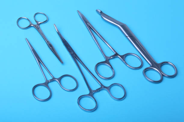 istock surgical instruments and tools including scalpels, forceps and tweezers arranged on a table for a surgery 943821732