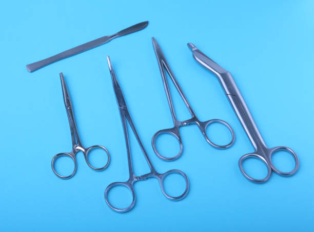 istock surgical instruments and tools including scalpels, forceps and tweezers arranged on a table for a surgery 943821802