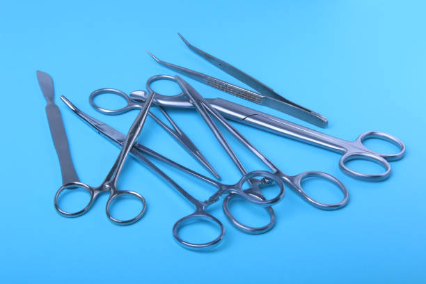 istock surgical instruments and tools including scalpels, forceps and tweezers arranged on a table for a surgery 943821828