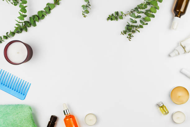 istock Flatlay frame arrangement with eucalyptus branches, candles, oils, serums and various beauty products  for hair and body. White background 943824078