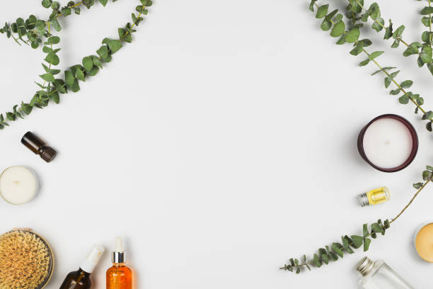 istock Flatlay frame arrangement with eucalyptus branches, candles, essential oil, body brush and various beauty products, white background, copyspace 943824100