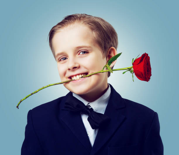 istock boy with a rose in his teeth 943826980