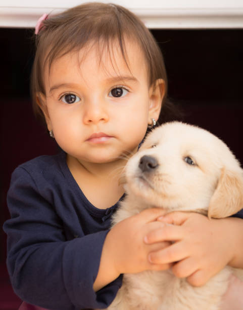 istock Little Baby Girl with Puppy 943827770
