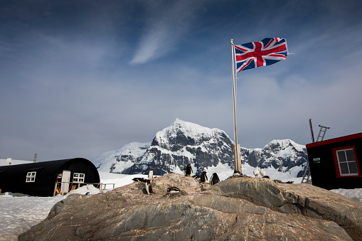 The British flag flies high over Port Lockroy, Antarctica which is home to the southernmost post office in the world. This post and research station is known as the Penguin Post Office because of the colony of Gentoo penguins who live there.