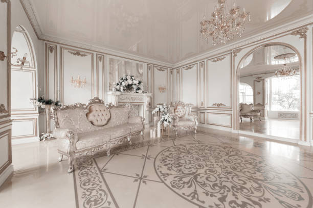 luxuriöse vintage interieur mit kamin in den aristokratischen stil. große fenster und spiegel. säulen und bögen, ornament auf dem glänzenden boden - domestic room palace chandelier nobility stock-fotos und bilder