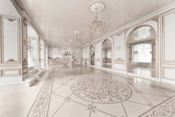 istock Luxurious vintage interior with fireplace in the aristocratic style. Large Windows and mirrors. Columns and arches, ornament on the glossy floor 943834734