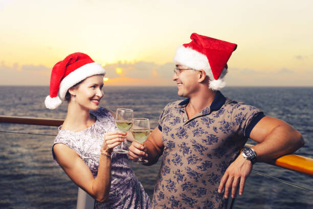 man and woman on cruise liner on christmas time - beach nautical vessel party clothing imagens e fotografias de stock