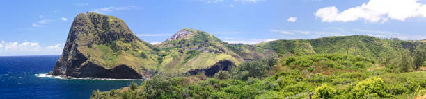 istock Maui Hawaii,Kahakuloa Head, panoramic,  Pacific ocean cliff and lush tree covered lava flows,north side of island 943837910