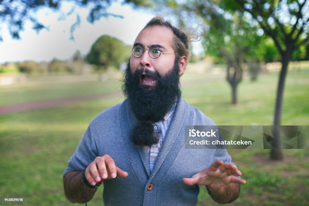 panic bearded man the fussy man is surprised, he is swinging to the left and right Shouting Stock Photo