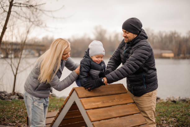 istock Smiling parents walking with a little son 943848080