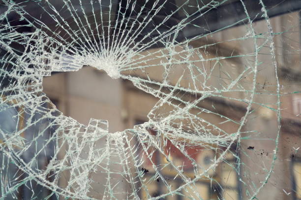 istock Hole in broken shattered security glass, insurance security crime concept 943848184