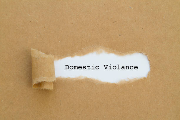 istock Domestic violance word written under torn paper. 943852120