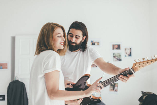 istock Girl on guitar lesson 943863768