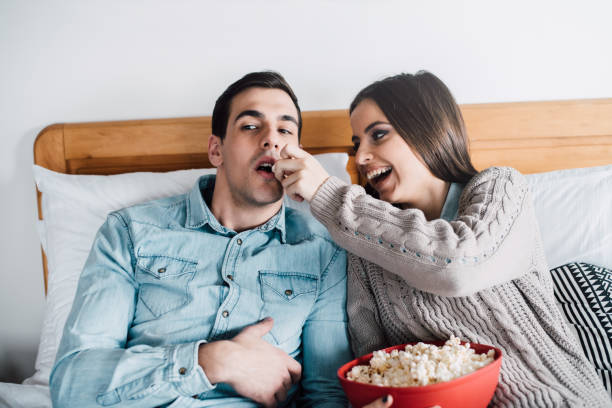istock Girlfriends feeding her boyfriend popcorn 943874926