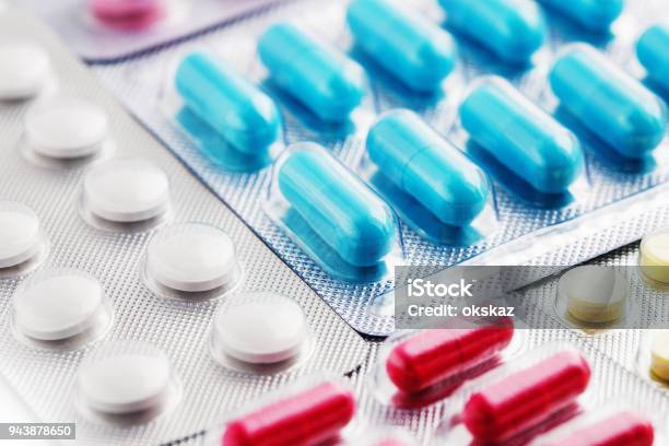 Heap Of Medical Pills In White Blue And Other Colors Pills In Plastic Package Concept Of Healthcare And Medicine Stock Photo - Download Image Now