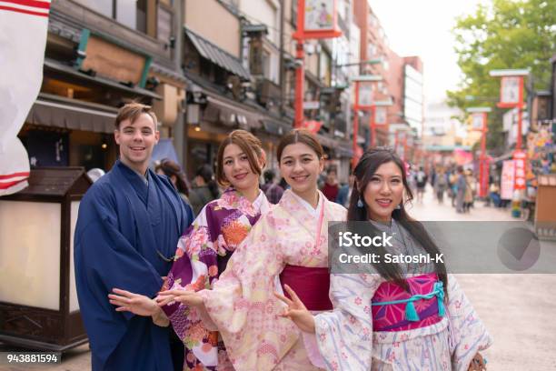 Multiethnic Group Of People In Kimono Standing In Traditional Japanese Town Stock Photo - Download Image Now