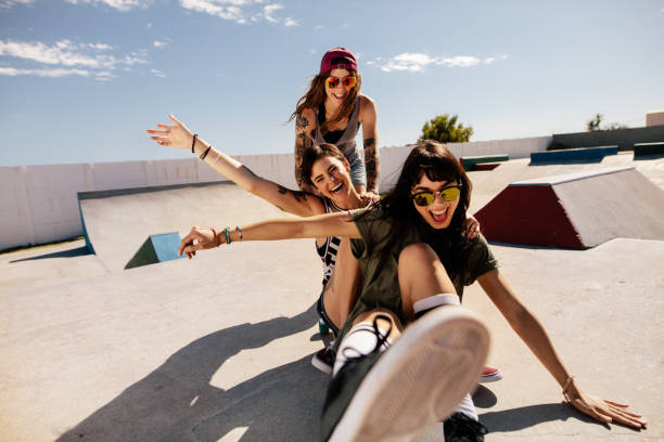 istock Friends playing with skateboard at the skate park 943885812