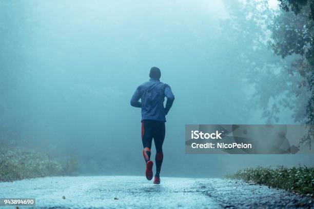 Motivated Young Man Running In The Rain Stock Photo - Download Image Now - Running, Track Event, Men