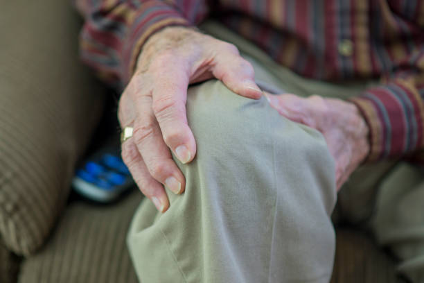 istock Senior Man Holding his Knee 943902804
