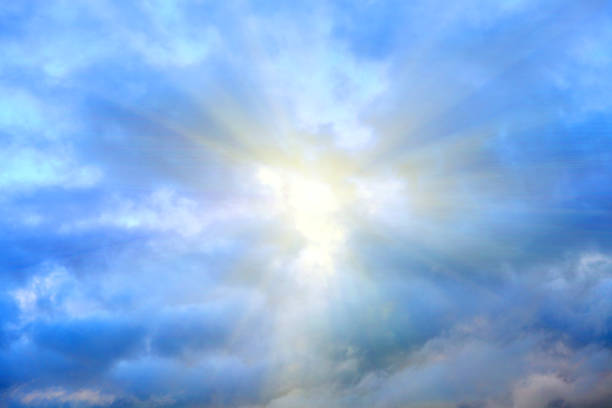 istock clouds against a blue sky with rays of the sun 943903370
