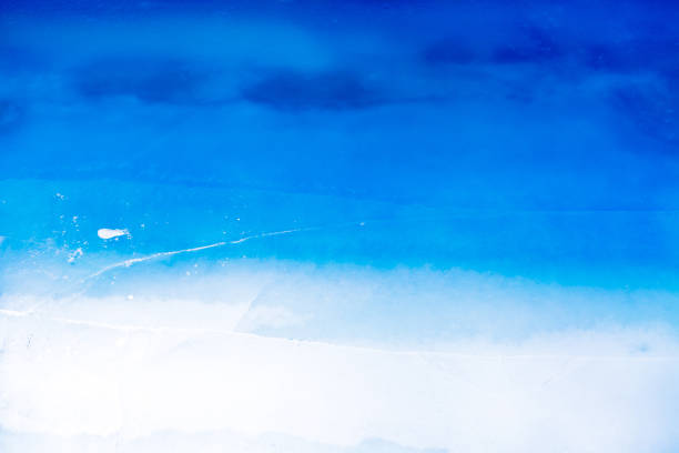 istock texture of a beautiful blue ice with cracks 943903374