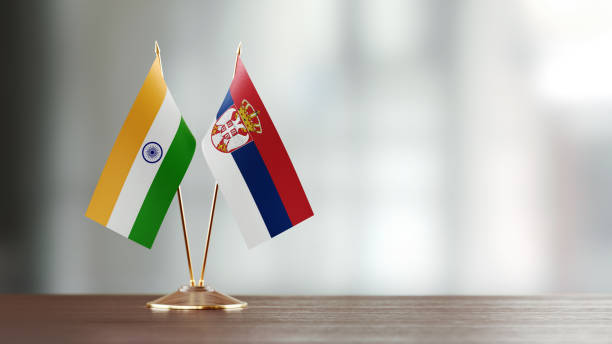 istock Indian And Serbian Flag Pair On A Desk Over Defocused Background 943914366