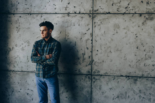 istock Caucasian man with crosed hands looking away through the window . 943914776
