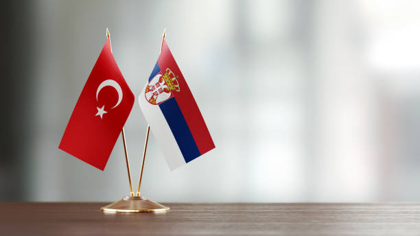 istock Turkish And Serbian Flag Pair On A Desk Over Defocused Background 943916864
