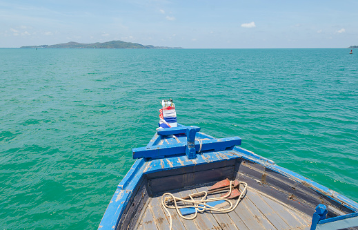 RAYONG, THAILAND - 2 JAN - Unidentified fishing boat with unidentified traveler passengers boating on ocean in Rayong, Thailand on January 2, 2016