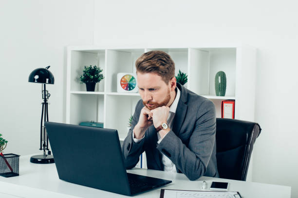 istock Concerned businessman looking at laptop 943920680