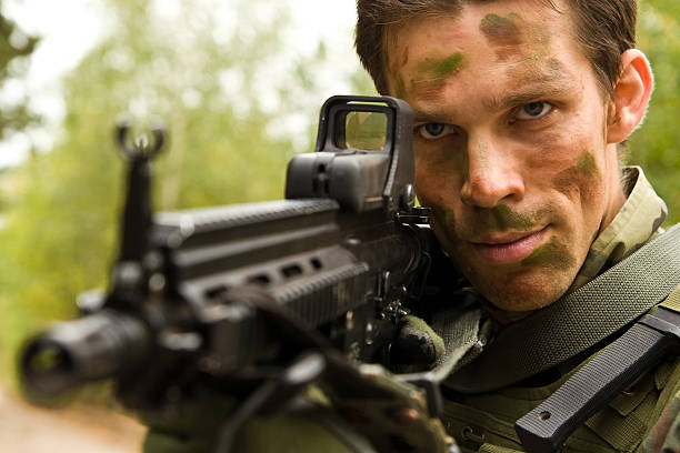 istock Airsoft player, man in camouflage with gun 94392253