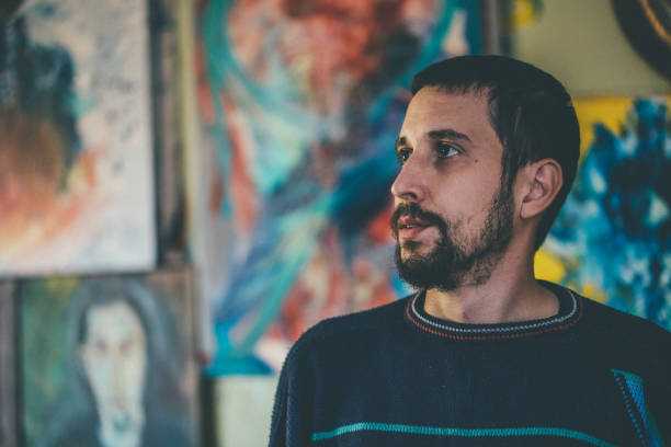 istock Artist surrounded by paintings 943924328