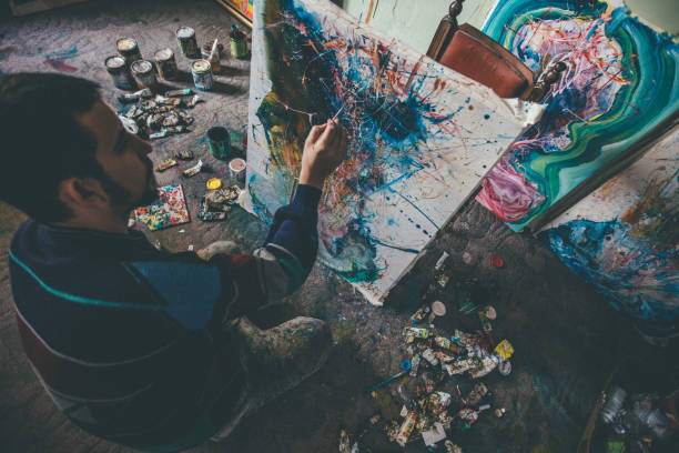 istock Guy painting on the floor 943927806