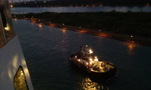 A tugboat escorts the cruise ship that I am on as it sails through the Panama Canal.