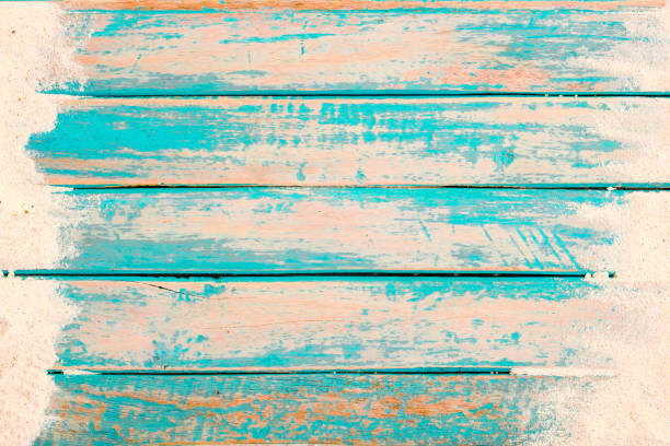 Beach background Beach background - top view of beach sand on old wood plank in blue sea paint background. summer vacation concept. vintage color tone. boardwalk stock pictures, royalty-free photos & images