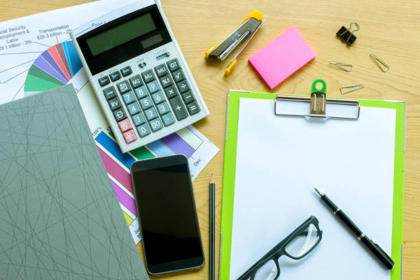 istock Businessman working on a laptop at office desk with paperwork and other objects around 943939188