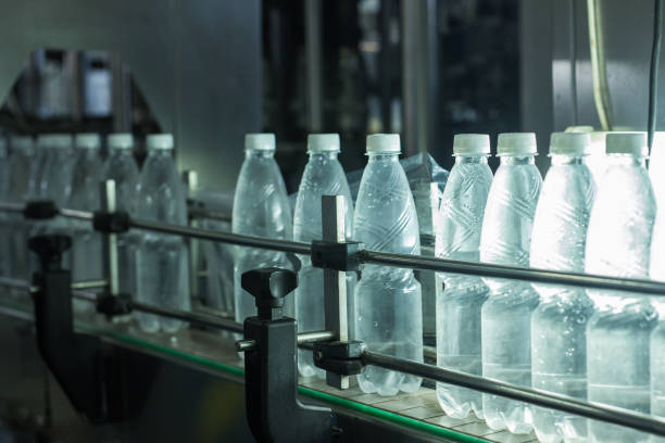 istock Water factory - Water bottling line for processing and bottling pure spring water into small bottles 943939464
