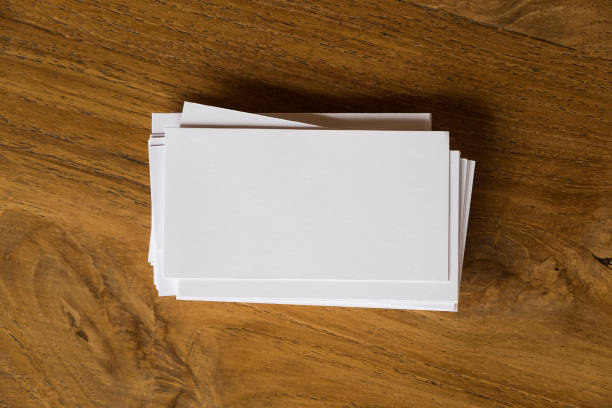 istock Top view image of stack of business card on wooden table background 943946536