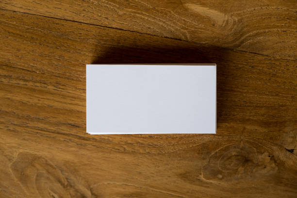 istock Top view image of stack of business card on wooden table background 943946608