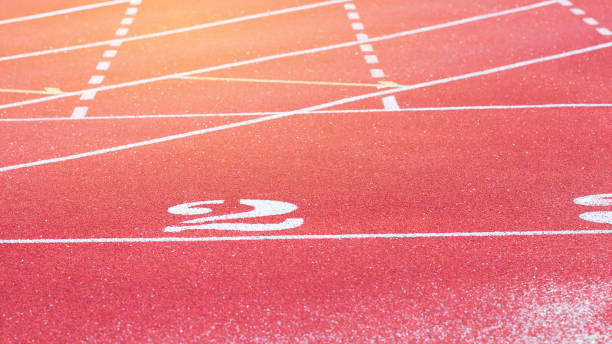 istock Empty Red Running track texture with lane number two, 2nd for background copy space, nobody runner tracks athietic competition in sunny day. 943950194