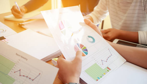 istock Co working team meeting concept: New Asian Genaration Business working and studying together with document graph paper in office discuss finance and marketing  solution reporting file in working place 943950366