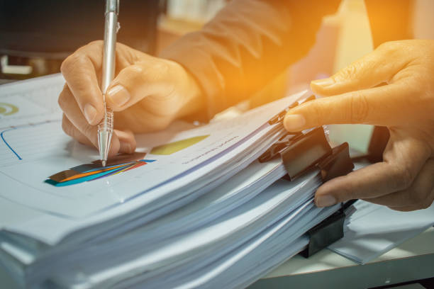 istock Businessman Preparing reports papers with graphs, charts on Stacks of documents files for finance in office. Piles of unfinished document achieves with paper clip. Concept of Business Annual Report. 943950672