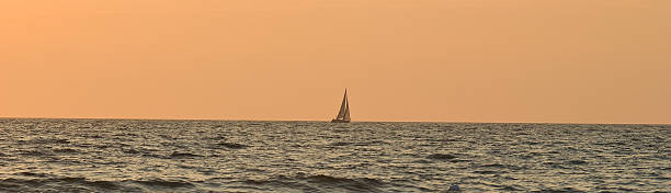 istock sea boat on the horizon 94395117