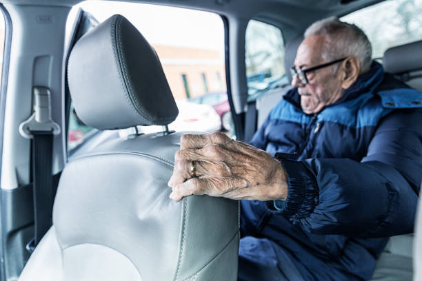 istock Frustrated Elderly Man Wrinkled Hand Gripping Car Seat 943963980