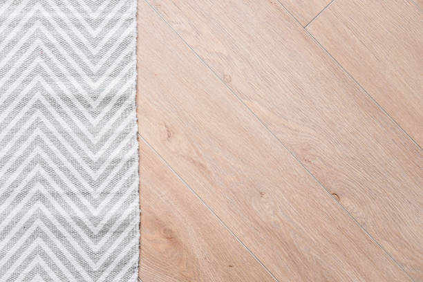 Light laminate parquete floor with carpet stock photo