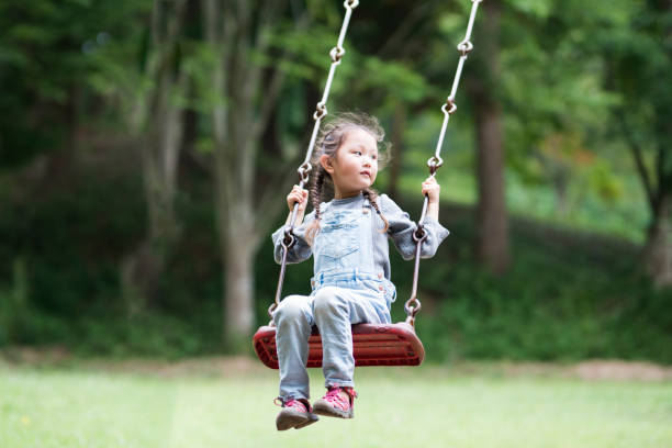 istock Little girl playing with a swing 943967644
