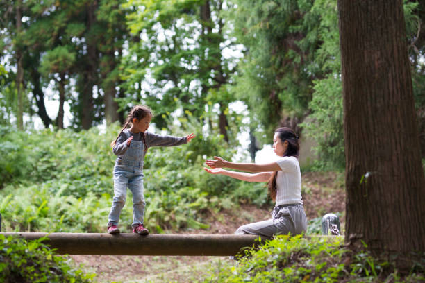 istock Mother and daughter playing in the park 943967690