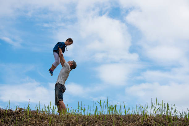 istock Father and daughter playing in the meadow 943968050